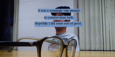 Glasses on a table, a drunk man in the background