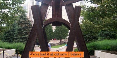 Girl sitting on a metal sculpture in the middle of Chicago