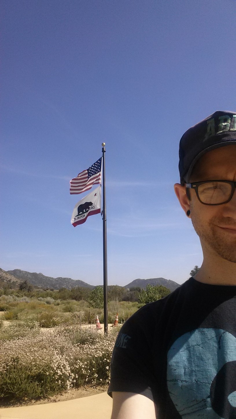 In front of flagpole in California