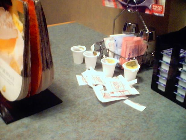 Empty sugar packets and coffee creamer