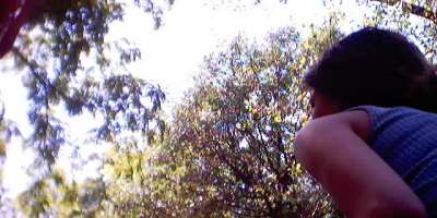 An olive shoulder and brown hair