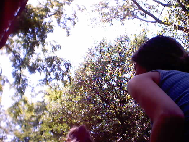 An olive shoulder and brown hair