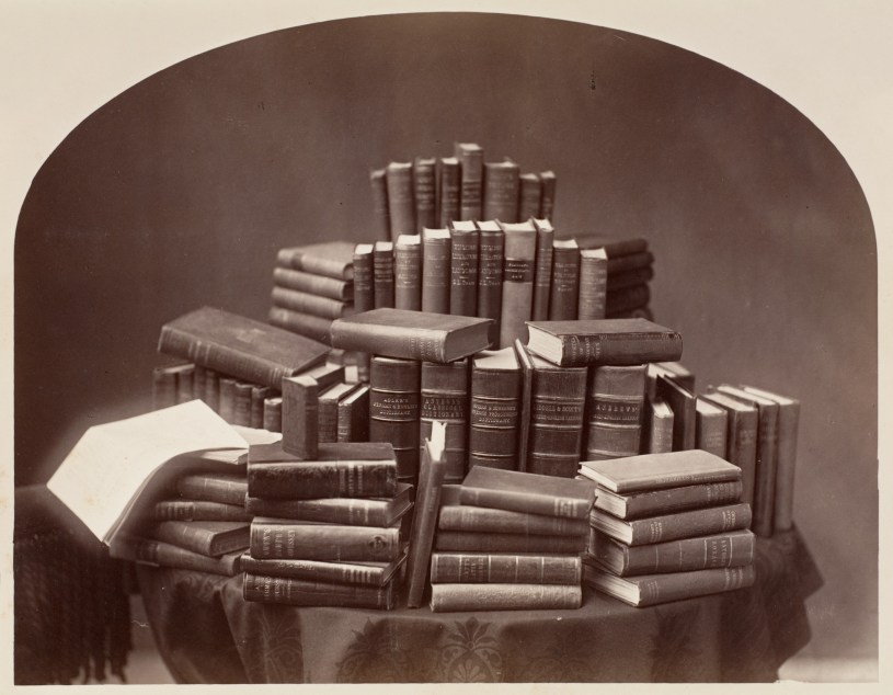Piles of old books in black and white