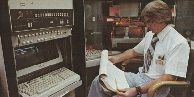 Man sitting at a computer in the 1970s